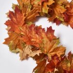 Close-up of greenery along the garland on this Classic Fall Harvest Maple Leaf Runner Mantel