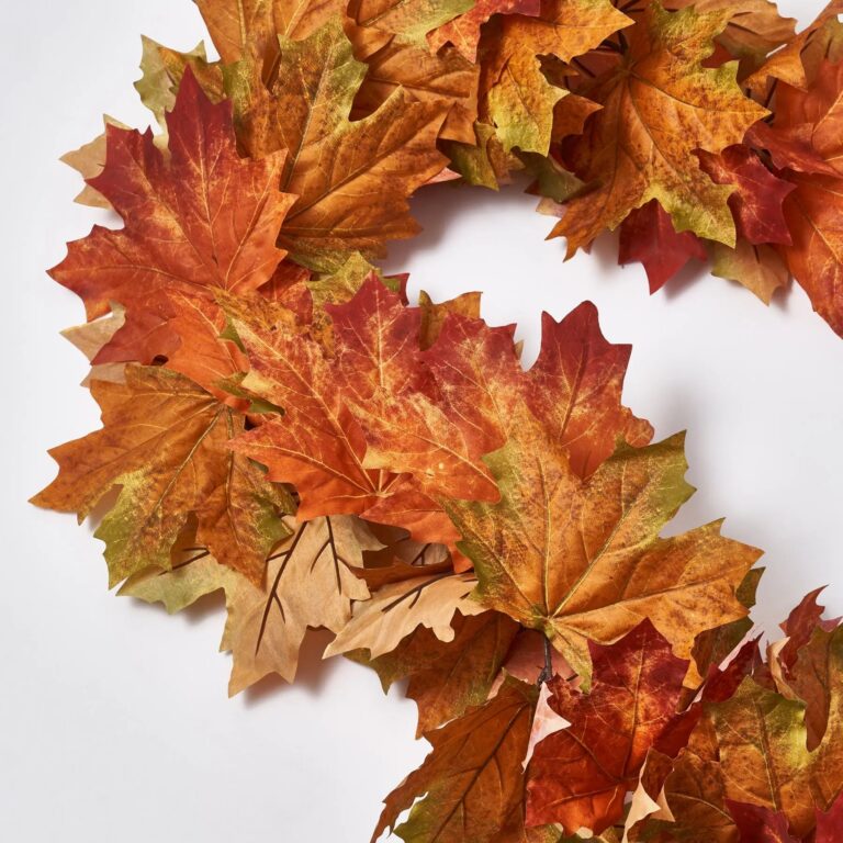 Close-up of greenery along the garland on this Classic Fall Harvest Maple Leaf Runner Mantel