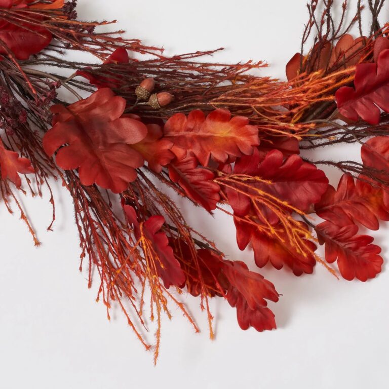 Close-up of greenery along the garland on this Fall Flame - Burgundy Red Runner Mantel