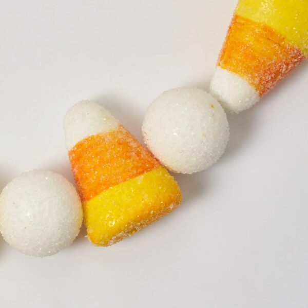 Close-up of greenery along the garland on this Sugar Frosted Faux Candy Corn Corn Fall