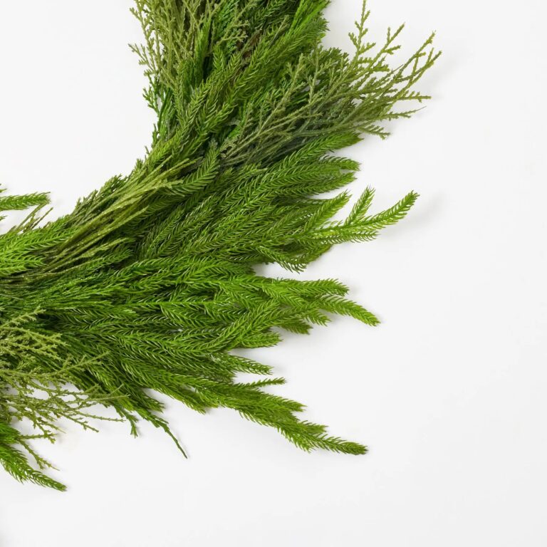 Close-up of greenery along the garland on this Deluxe Real Touch Winter Greenery Christmas Mantel