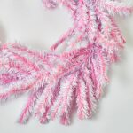 Close-up of greenery along the garland on this Deluxe Pink and White Candy Mantel Stairway