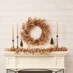 Detail view of berry and foliage detail from the Shiny Metallic Gold Boxwood Christmas Mantle