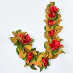 Close-up of greenery along the garland on this Classic Christmas Real Touch Red Holiday Mantel