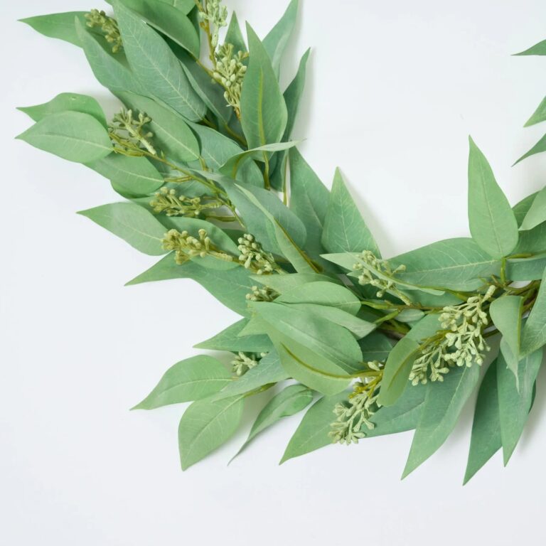 Close-up of greenery along the garland on this All Seasons Faux Blade Eucalyptus Eucalyptus Mantel