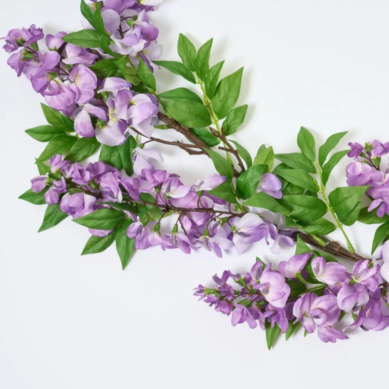 Close-up of greenery along the garland on this Draping Purple Wisteria Blooms Whimsical Spring Mantel