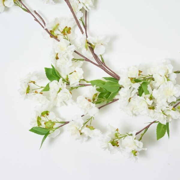Close-up of greenery along the garland on this White Cherry Blossom Mantel Garland Blossom Mantel