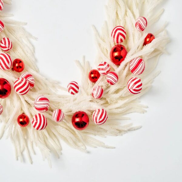Close-up of greenery along the garland on this Peppermint Balls and Real Touch Christmas Mantle