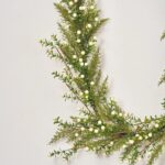 Close-up of greenery along the garland on this Cream White Berry and Boxwood Runner Mantle