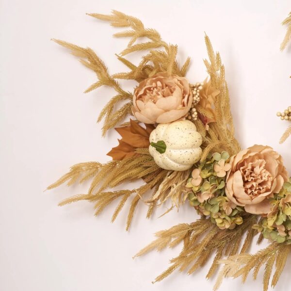 Close-up of greenery along the garland on this Pumpkin Meadow Beige Norfolk Pine, Fall Mantle