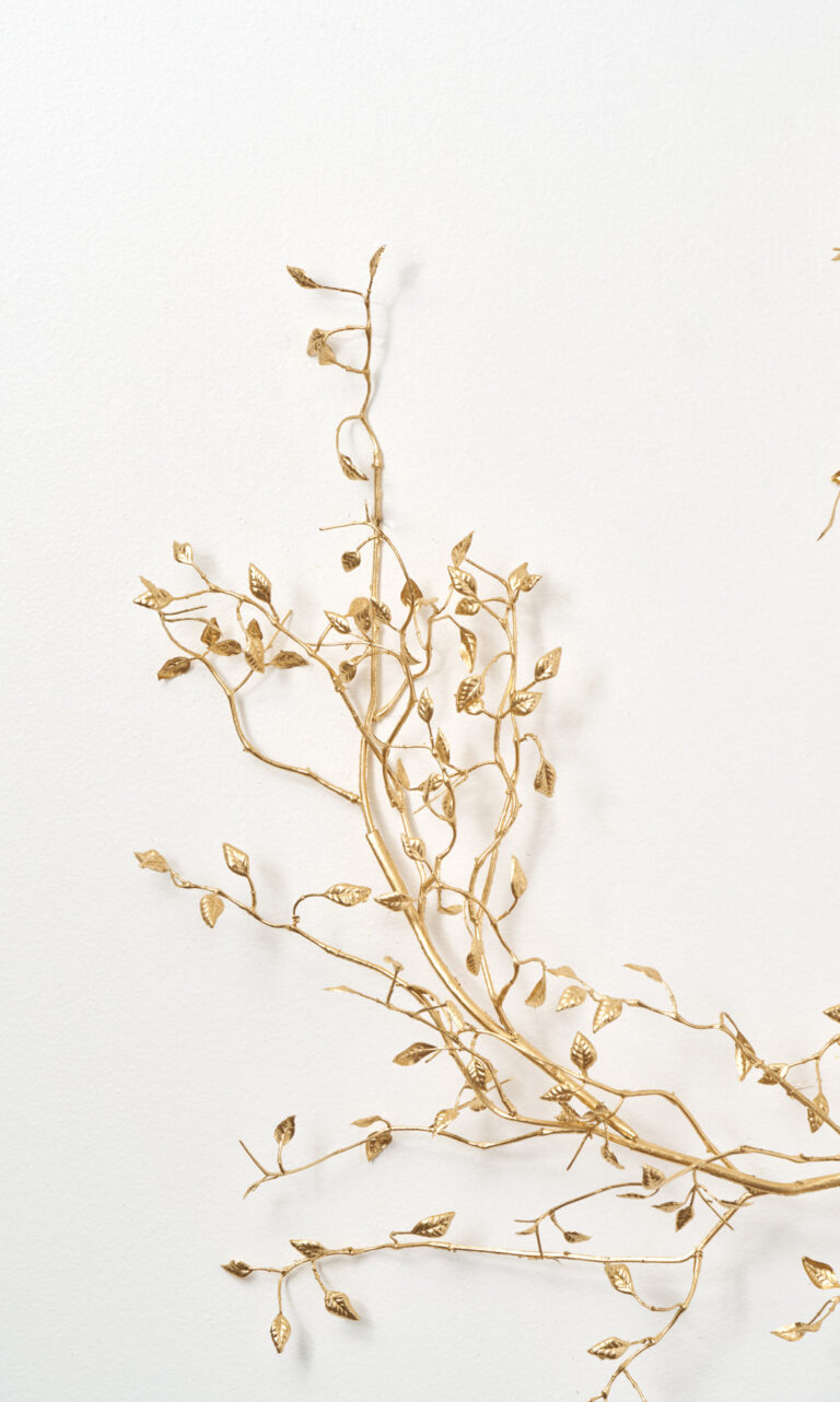 Close-up of greenery along the garland on this Gold Metallic Mini Leaf Branch Branch Accent