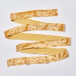 Close-up of blooms and berries on this Golden Mustard Raw Edge Frayed Frayed Velvet Ribbon