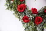 Alternate angle of the Winter's Romance Red Rose, Juniper, Heart Valentine Wreath showing wreath face