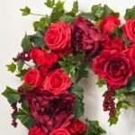 Close-up of blooms and berries on this 50 Shades of Red Valentine's Heart Wreath