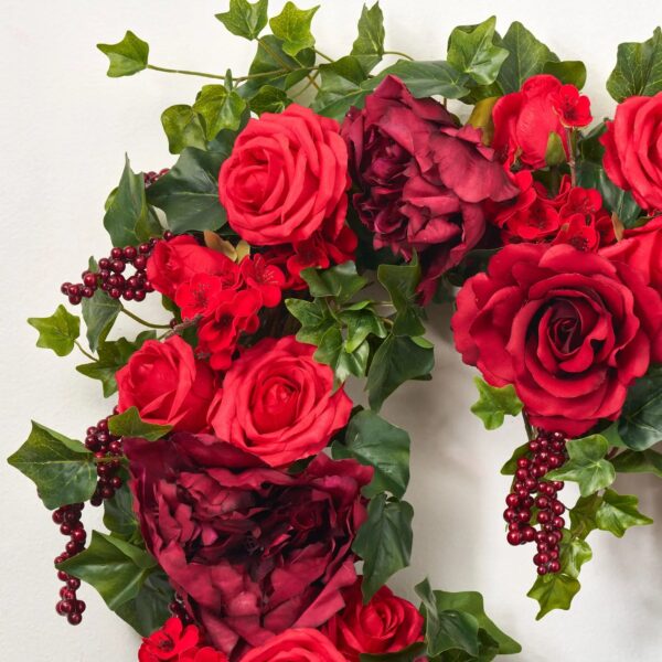 Close-up of blooms and berries on this 50 Shades of Red Valentine's Heart Wreath