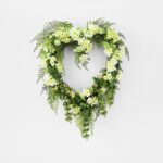 Close-up of blooms and berries on this Lucky In Love - Bells Day Heart Wreath