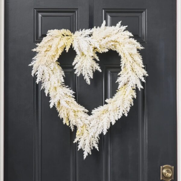 Close-up of blooms and berries on this Ivory Pampas of the Heart Grass Heart Wreath