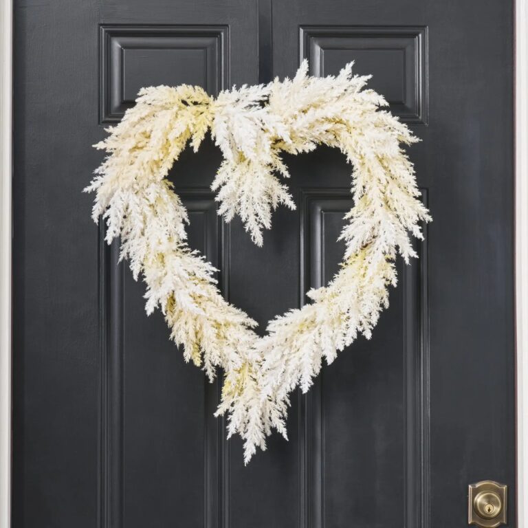 Close-up of blooms and berries on this Ivory Pampas of the Heart Grass Heart Wreath