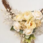 Close-up of blooms and berries on this From The Bottom of My Day Heart Wreath