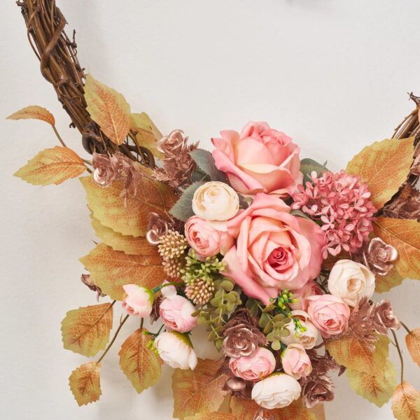 Close-up of blooms and berries on this From The Bottom of My Day Heart Wreath