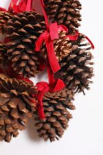 Alternate angle of the Multi Pinecone Christmas Hanging Decor Red Velvet Ribbon showing full swag