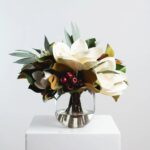 Alternate angle of the Holiday White Magnolia, Red Crabapple Glass Vase showing bloom arrangement in