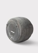 Side view of the Distressed Rustic Concrete Vase - 7 inch Tall revealing bloom arrangement