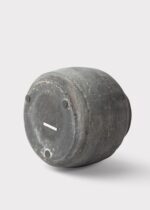 Side view of the Distressed Rustic Concrete Vase - 7 inch Tall revealing bloom arrangement