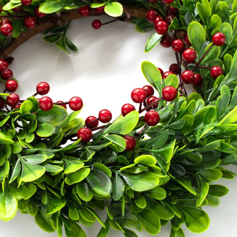 Close-up of blooms and berries on this Holiday Boxwood and Red Berry Mini Wreath Candle