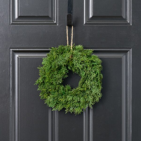 Close-up of blooms and berries on this Lifelike Cedar Faux Winter Greenery Mini Candle Wreath