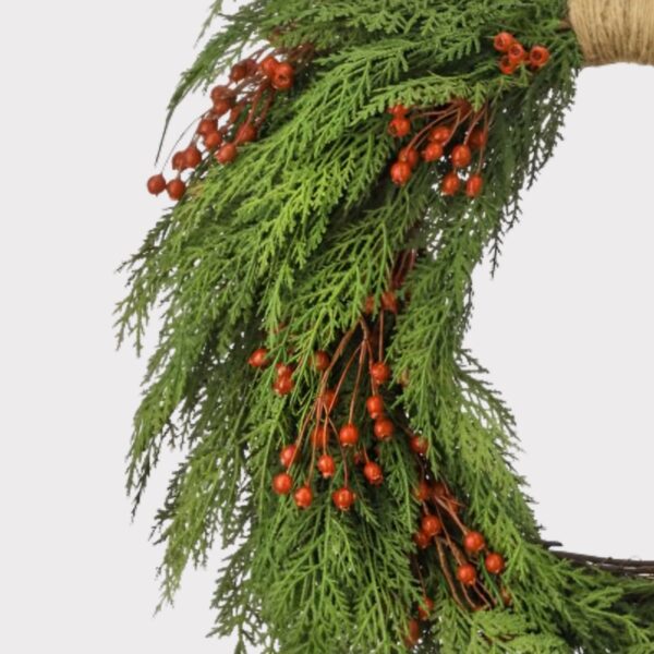 Close-up of blooms and berries on this Real Touch Cedar and Red Artificial Holiday Wreath