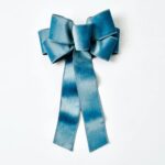 Close-up of blooms and berries on this Soft Blue Taffeta Wire Drape Loop Bow
