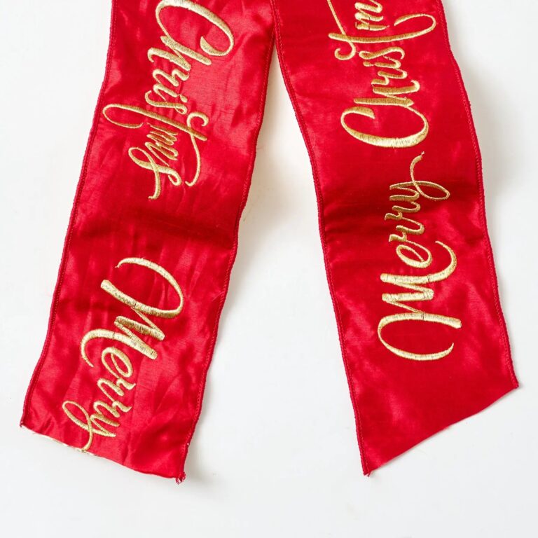 Close-up of blooms and berries on this Extra Large Red and Gold Center Loop Bow
