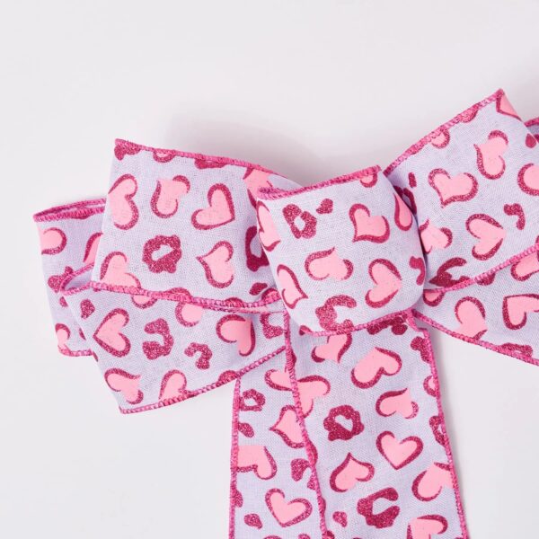 Close-up of blooms and berries on this Pink and Purple Glittered Heart Hand Tied Bow