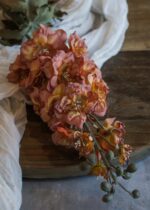The Artificial Larkspur Flower in Orange and Pink - shown in full, highlighting petal texture