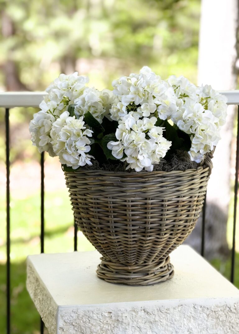 Close-up of vase silhouette detail on this Handmade Rattan Footed Basket Rattan Footed Basket