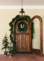 Close-up of blooms and berries on this Afloral Real Touch Norfolk Pine Norfolk Pine Wreath