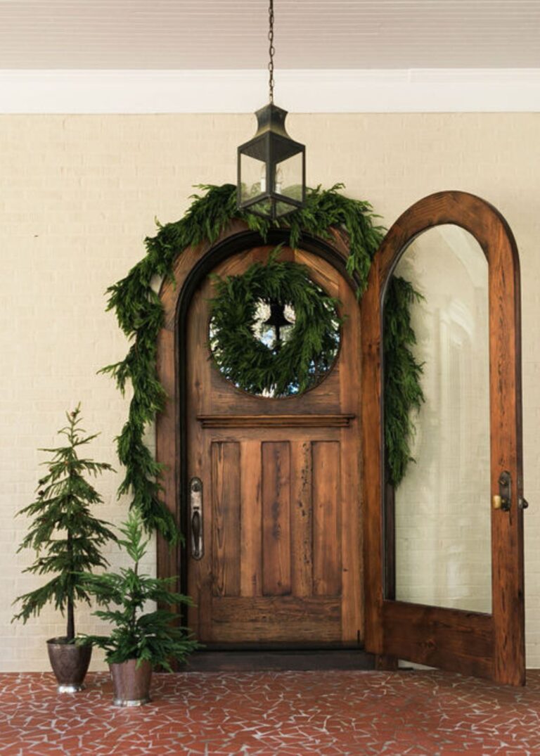 Close-up of blooms and berries on this Afloral Real Touch Norfolk Pine Norfolk Pine Wreath