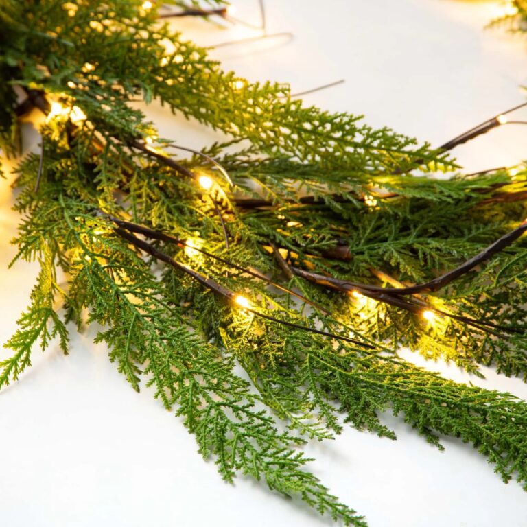Close-up of greenery along the garland on this Pre - lit Real Touch Christmas Mantle