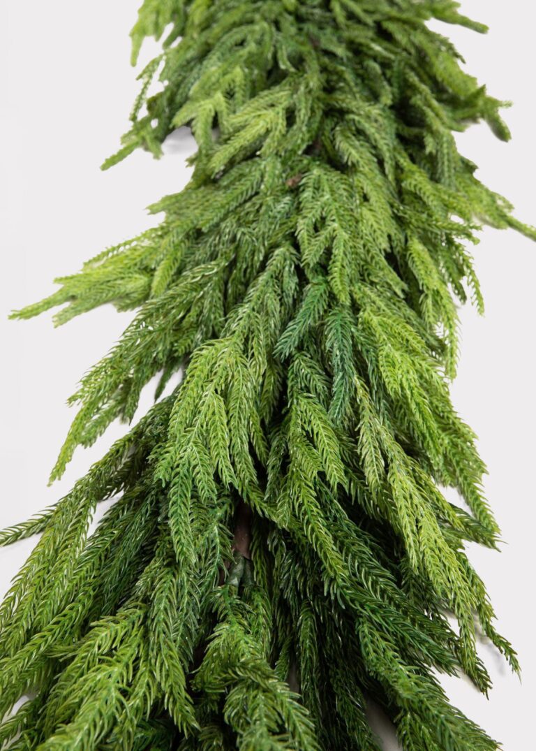 Close-up of greenery along the garland on this Real Touch Deluxe Norfolk Norfolk Pine