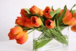 Alternate angle of the Real Touch Tulip Spring Floral Oval Glass Vase showing vase silhouette