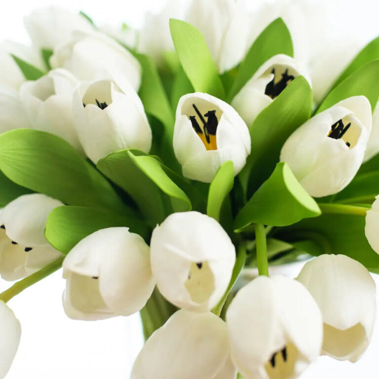 Close-up of vase silhouette detail on this Real Touch White Tulip Everyday Luxury Glass Urn