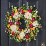 Close-up of blooms and berries on this White and Fuchsia Peony Front Door Wreath