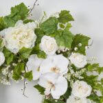 Detail view of layered greenery detail from the White Real Touch Orchid, Peony Front Door