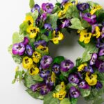 Close-up of blooms and berries on this Pansy Perfection - Mixed Yellow Front Door Wreath