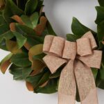Close-up of blooms and berries on this Classic Real Touch Magnolia Leaf Burlap Bow