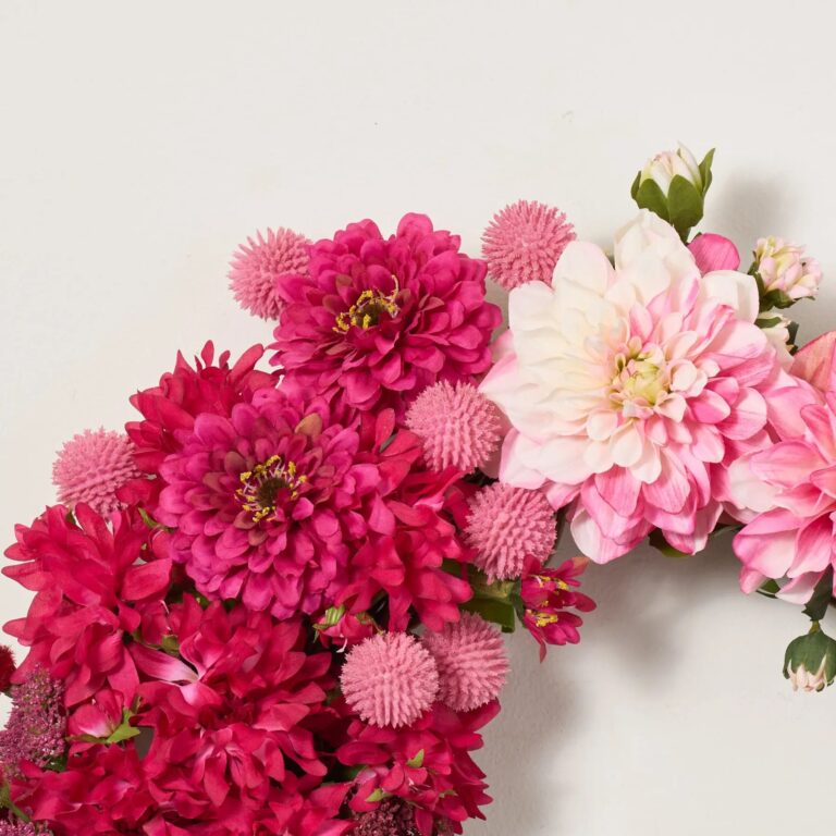 Close-up of blooms and berries on this Cute As A Button Front Door Wreath