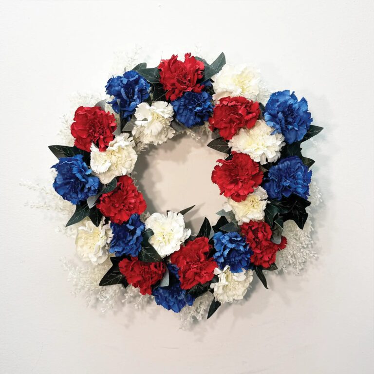 Close-up of blooms and berries on this Oh Say Can You See Front Door Wreath