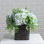 Side view of the Soft Blue Hydrangea and Mixed Tin Window Planter revealing frond and