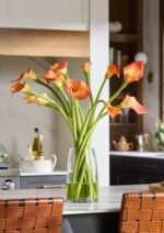 Close-up of vase silhouette detail on this Orange Artificial Calla Lily Arrangement Glass Vase